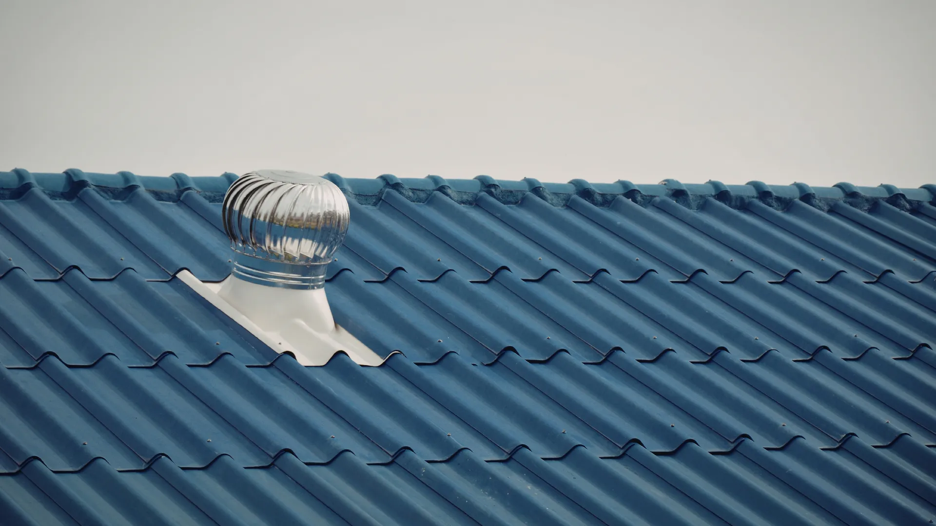 Close-up of a roofline with vented soffit panels and clean fascia board along a Utah County residential home